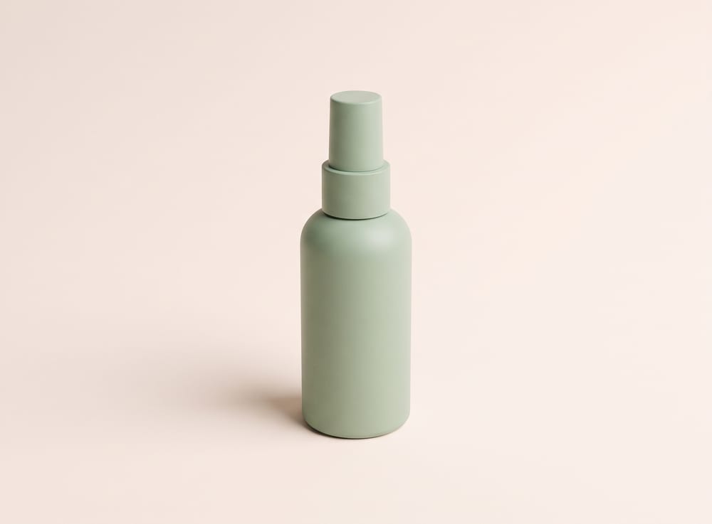 A plain sage-green fine-mist spray bottle.